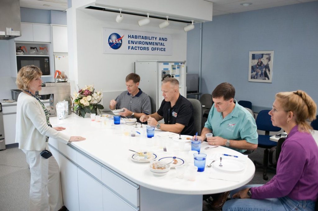 Crew members participate in a food tasting in the Habitability and Environmental Factors Office at NASA Johnson Space Center.