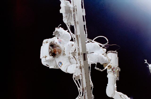 NASA astronaut Susan Helms takes part in the longest single spacewalk (2001).
