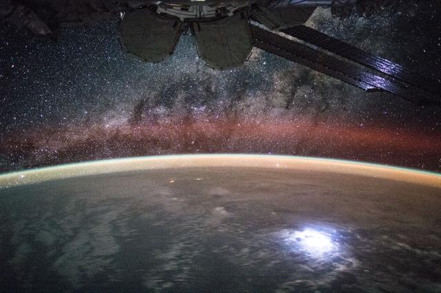 Photo of lightning on Earth and Milky Way above, taken aboard the ISS.