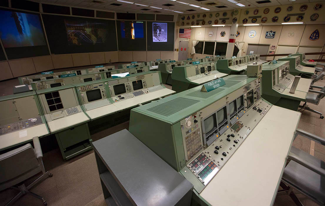 An overall view of the consoles used in Historic Mission Control. The consoles used by multiple flight directors contained no computing elements - they displayed only different information channels coming in from the mainframe. Of the hundreds of buttons, monitors and controls located at these flight controller stations, many have gone missing or have become faded after decades of use.