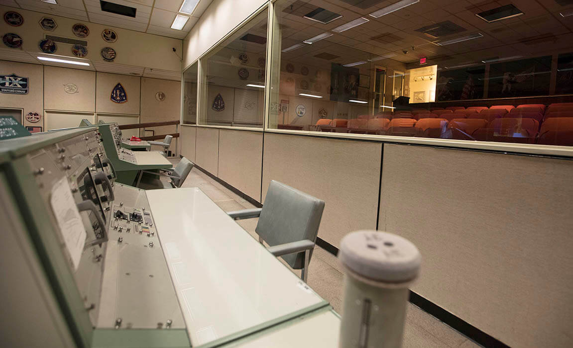 The last row in Historic Mission Control hosted the stations of Public Affairs Office, Director of Flight Operations, Mission Operations Directorate and Department of Defense. The iconic red phone located at the Department of Defense station was used to directly call the Navy when a capsule returning to Earth was about to splashdown. On the right is the viewing room of 74 seats that hosted the families of astronauts and special guests.